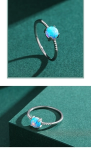 Macro shot of S925 silver ring featuring a round lab opal and sparkling pavé zircons