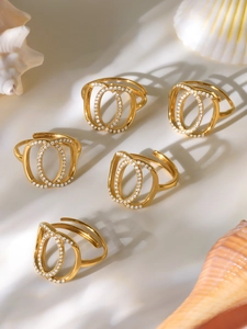 Detailed view of five adjustable gold rings with double oval layers and zircon stones