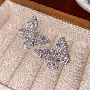 Detailed view of silver butterfly stud earrings with sparkling cubic zirconia stones