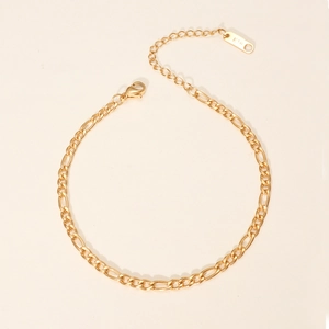 Detail of 18K gold plated stainless steel Figaro chain bracelet with K18 engraved tag
