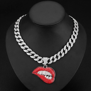 Close-up of hip hop silver Cuban chain with sparkling red rhinestone biting lips pendant