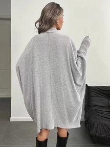 Rear view of oversized grey knitted dress with vertical ribbed texture and batwing sleeves