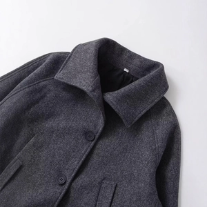 Short wool coat for women in dark grey featuring a wide lapel and single-breasted buttons