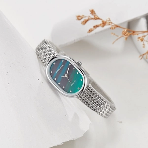 Detail of oval quartz watch with green malachite dial and silver Milanese mesh strap