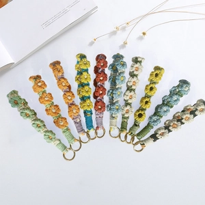 Handmade crochet flower keychains in various colors with golden metal rings
