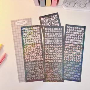 Macro shot of laser sparkling black letter and number stickers for idol card decoration