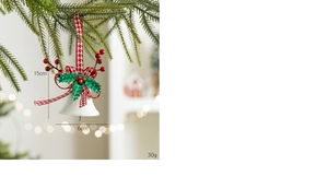 Detailed view of 15cm white Christmas bell with red bow and berries on pine branch