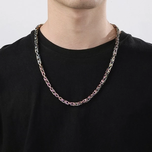 Macro detail of 6mm rainbow stainless steel Byzantine chain necklace for men on black shirt
