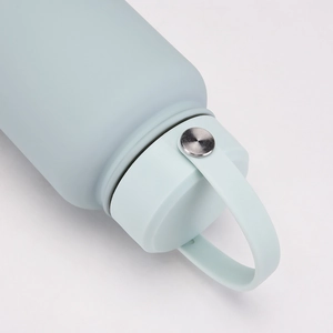 Detail of light blue sports water bottle cap with handle and matte texture