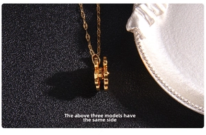 Detailed side view of golden H-shaped pendant with polished finish and thick profile