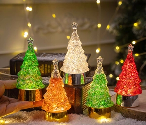 Close-up of LED glowing crystal Christmas tree with color-changing light and metallic base