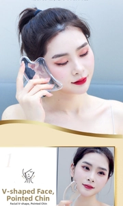 Detailed close-up showing resin facial gua sha tool massaging the jawline for V-line shaping