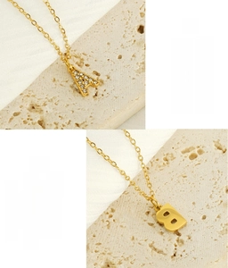 Detail of gold stainless steel initial pendant necklace with crystal zircons inlay