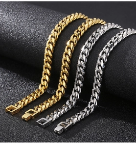 Detail of high-polished gold and silver stainless steel Cuban link chains with box clasps