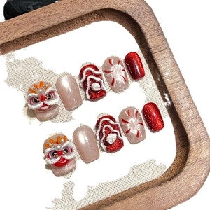 Cute red lion dance press-on nails with 3D handmade New Year designs and glitter accents