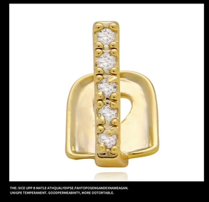 Detail of single gold dental grillz set with six sparkling clear cubic zirconia stones