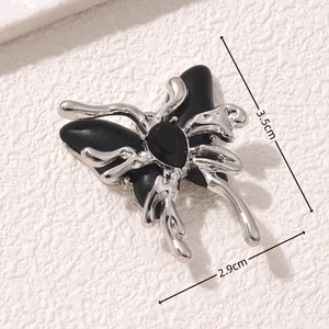 Gothic butterfly pendant in silver metal with black inlay measuring 3.5cm by 2.9cm