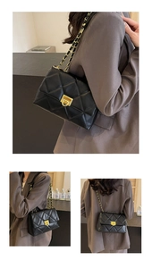 Detailed view of black quilted faux leather crossbody bag with gold chain and clasp