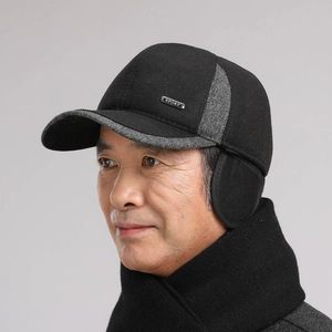 Detail of warm winter baseball cap for men featuring foldable ear flaps and sport metal tag