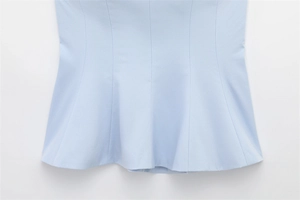 Close-up of light blue summer top showing detailed woven texture and stitching craftsmanship