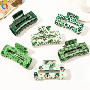 Detailed top view of St. Patrick's Day hair claws with clovers and gnome patterns