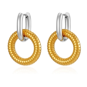 Macro detail of two-tone stainless steel oval earrings with golden textured texture