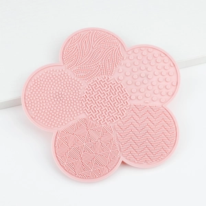 Pink flower-shaped silicone makeup brush cleaning mat with multiple textured surface zones