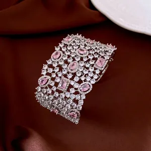 Luxury vintage silver bangle with pink gemstones and zircon pavé on brown satin fabric