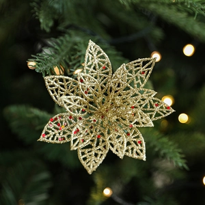 Fleur de poinsettia dorée à paillettes pour décoration de sapin avec effets de lumière bokeh