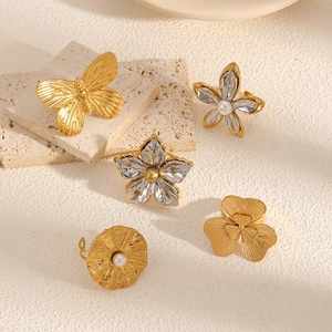 Elegant gold and silver flower petal rings set with pearls on textured stones