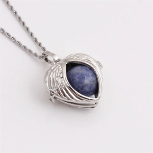 Silver plated heart wing necklace featuring a vibrant blue sphere pendant on white background