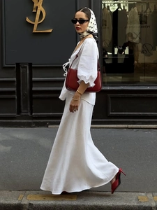 Close-up of white two-piece set with puffed sleeves and long skirt in French street style