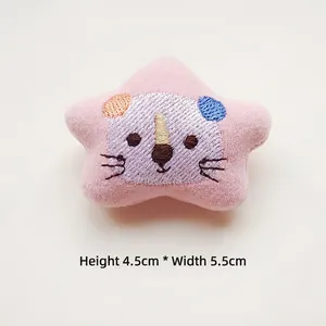 Pink plush star doll brooch with animal embroidery detail measuring 4.5cm by 5.5cm