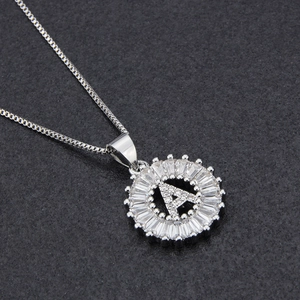 Macro shot of silver letter A pendant with sparkling zircon inlays on box chain necklace
