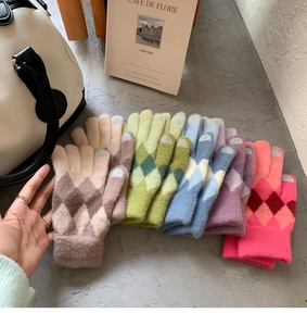 Detail of touchscreen knitting gloves with argyle pattern and various trendy colors