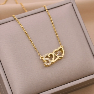 Detailed close-up of a gold 520 heart pendant necklace featuring sparkling inset gemstones