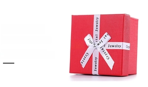 Macro detail of red textured square jewelry box with a white Crystal Jewelry ribbon bow