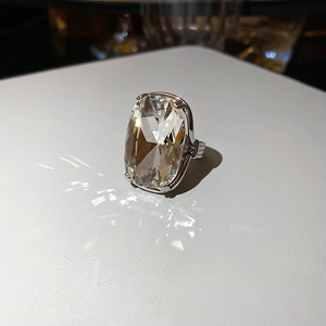 Macro shot of silver ring featuring a large rectangular cut diamond in a claw setting
