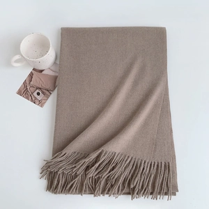 Folded soft cashmere-like scarf in camel brown with elegant tassel details
