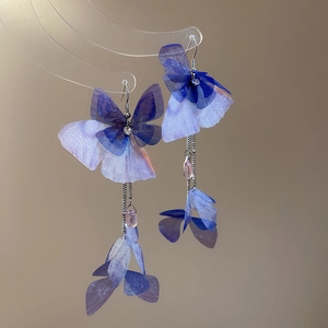 Detail of blue purple butterfly earrings with elegant long tassel and waterdrop crystal