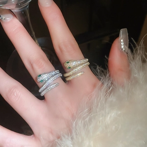Detail of snake wrap rings in gold and silver plating with white cubic zirconia crystals