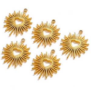 Macro view of five polished gold heart pendants with radiant texture on white background