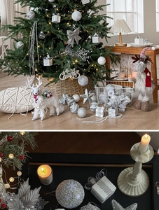 Close-up of silver glitter ornaments, white deer, and star toppers for Christmas decor