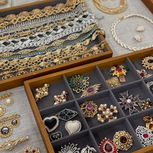 Vintage luxury jewelry collection with brooches and necklaces in gold and silver finish