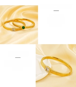 Close-up of gold stainless steel bangle set with green gemstone and square zircon stones