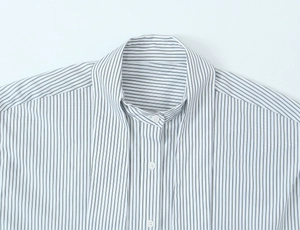 Detailed view of striped poplin shirt neckline with stylish scarf tie and neat stitching