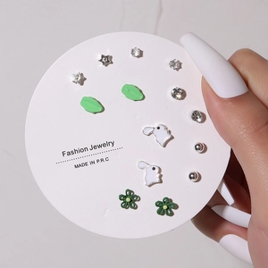 7-pair minimalist stud earring set with stars, flowers, and rhinestones on white card