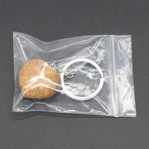 Natural bumblebee jasper heart keychain with silver metal ring in clear packaging