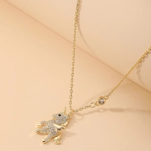 Detail of gold unicorn pendant with micro-paved zircons and delicate link chain