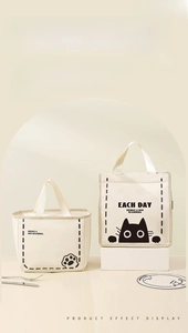Close-up of waterproof thermal lunch bag with cat print and durable fabric handles